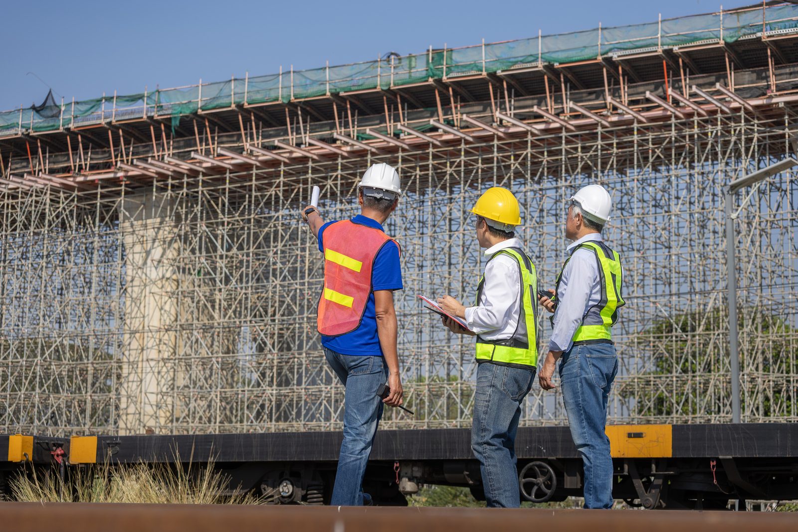 Engineers inspecting scaffolding on an infrastructure project