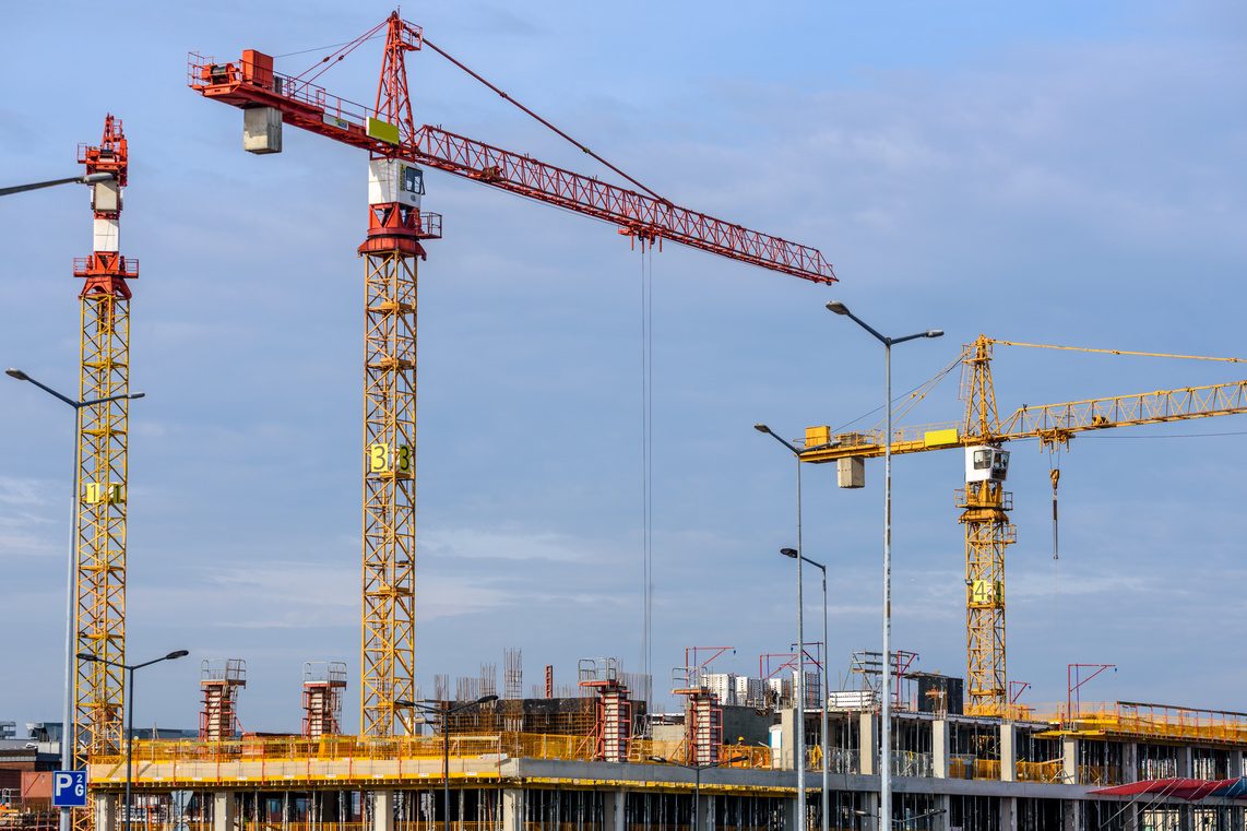 Tower cranes operating on an active construction site